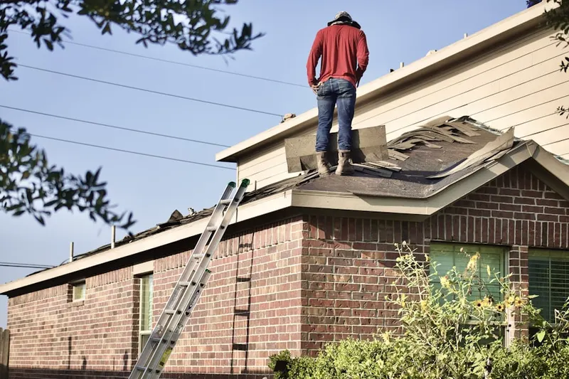 Professional roofer working on a residential roof in East Longmeadow